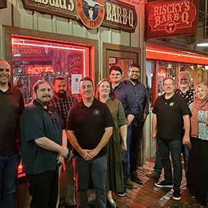 The team posed for a group photo after enjoying a classic Texas BBQ together.